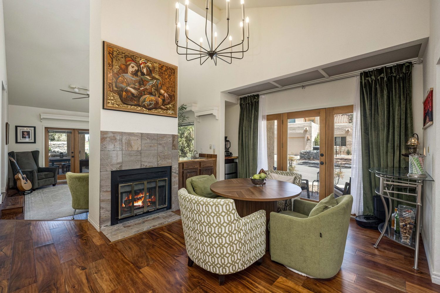 Living room with tiled fireplace and vaulted ceilings
