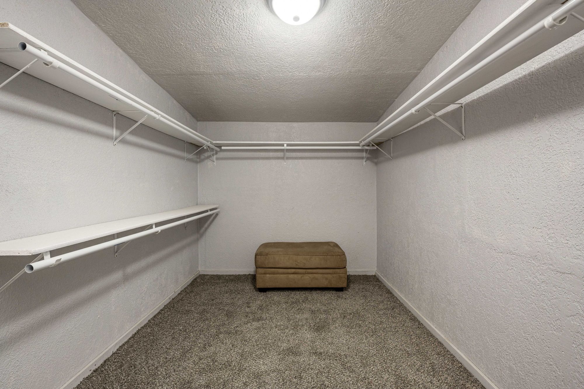 Walk-in closet with built-in shelving and hanging rods