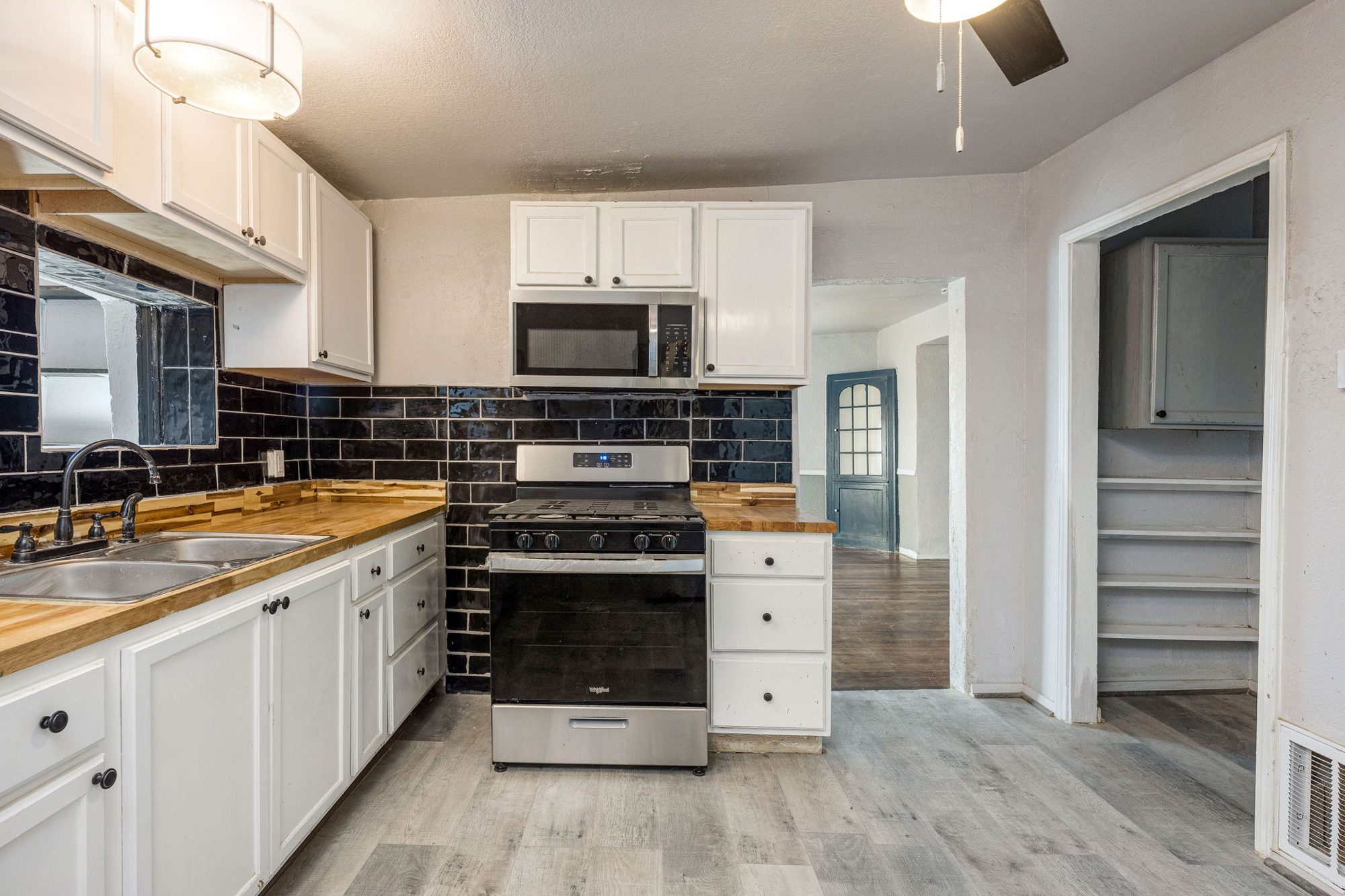 Kitchen with gas range and a walk-in pantry with shelving