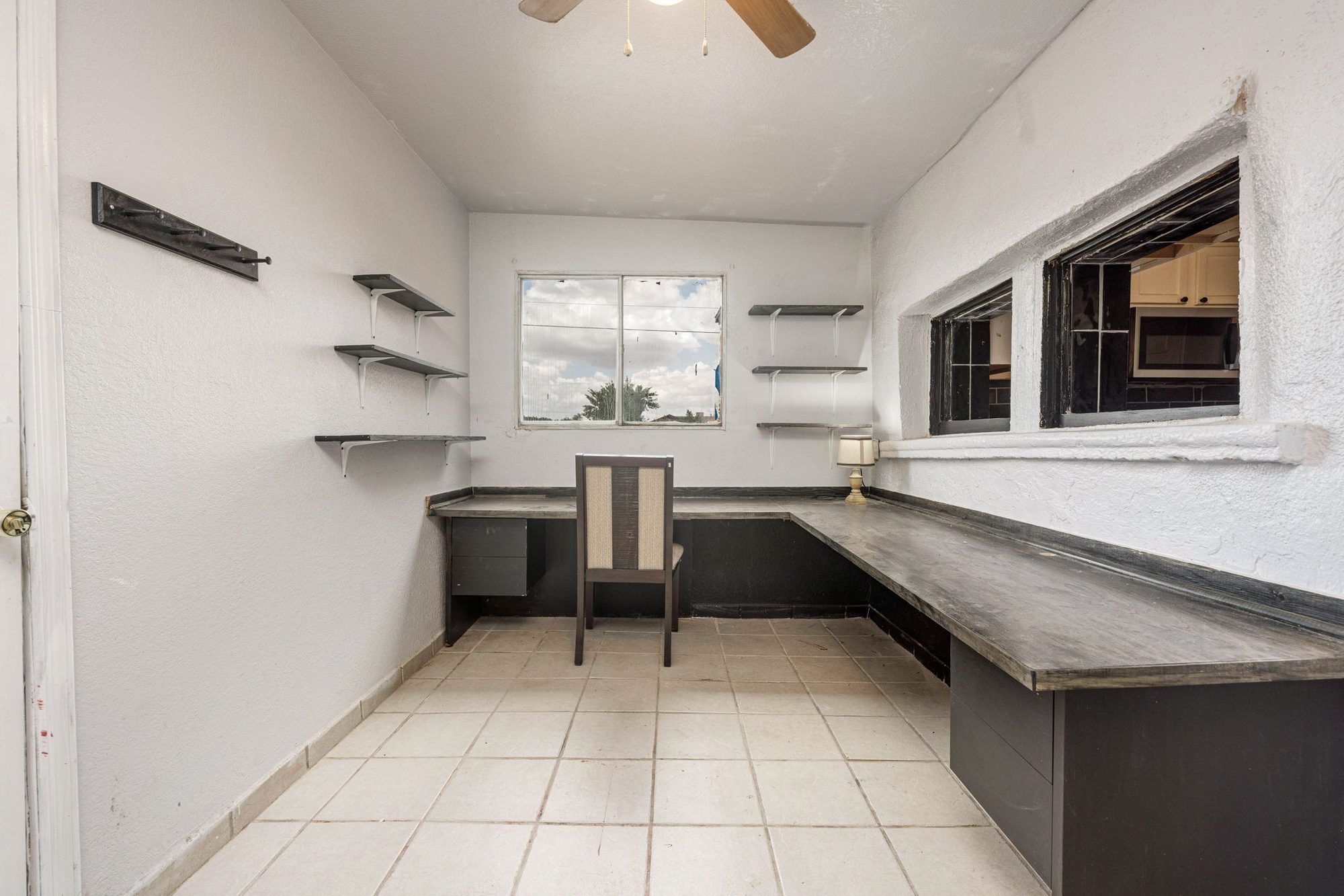Office with a built-in desk and shelving