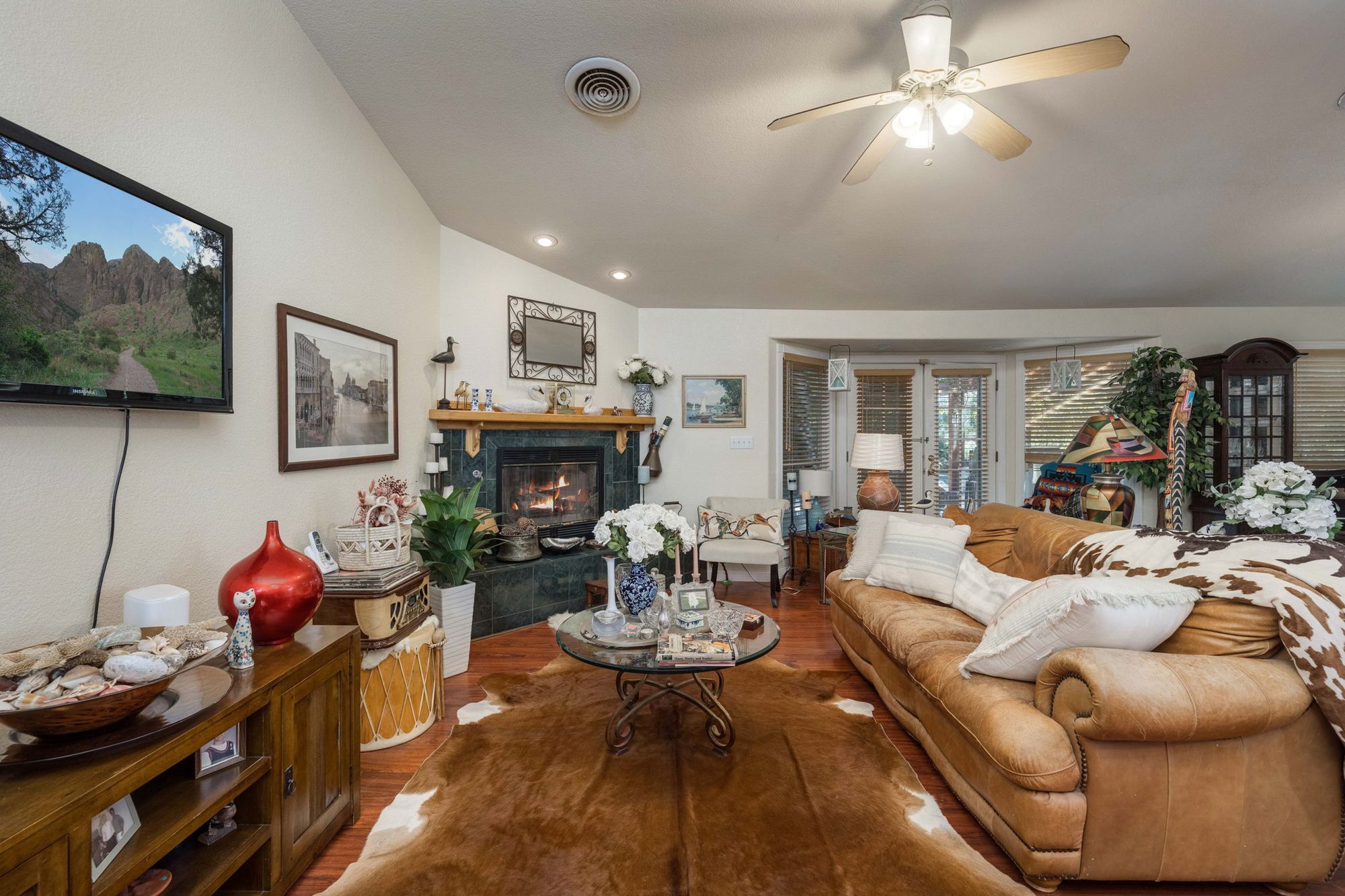 Living room with vaulted ceiling and fireplace