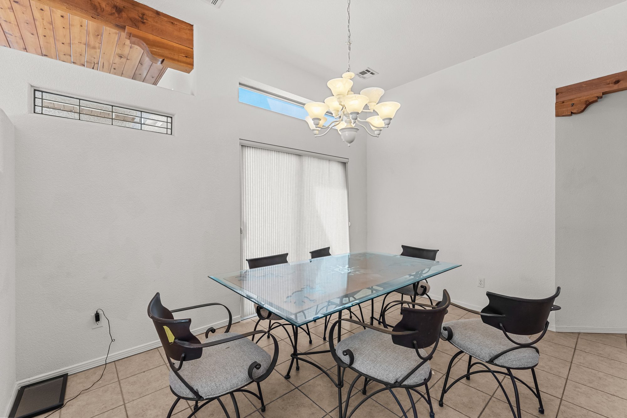 Formal dining room with sliding door and high windows