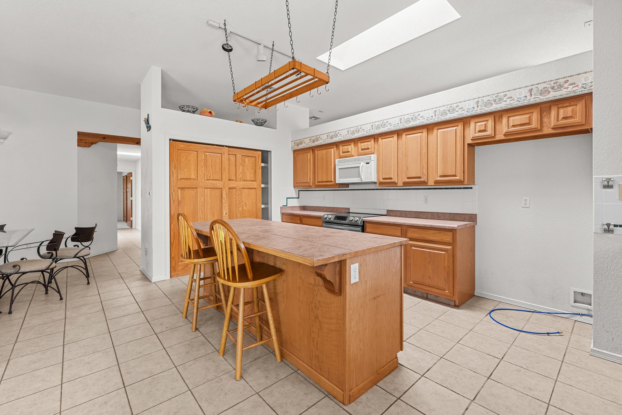 Kitchen island with breakfast-bar seating and pantry
