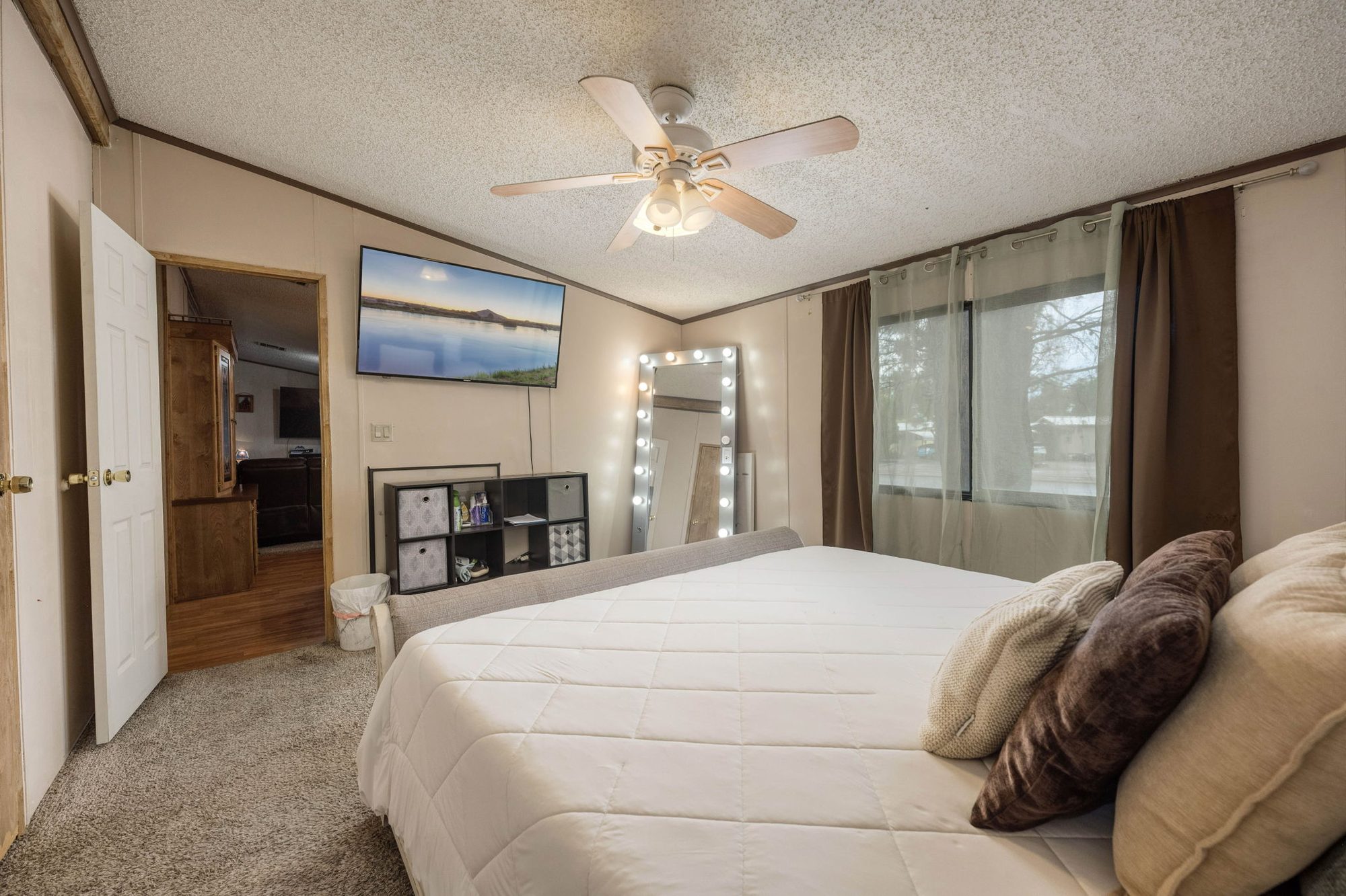 Primary bedroom with ceiling fan and large window